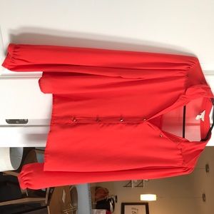 Stylish bright orange blouse with gold studs